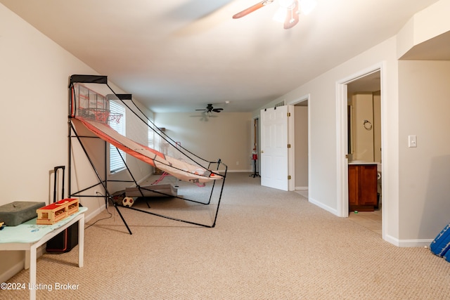 game room with light colored carpet and ceiling fan