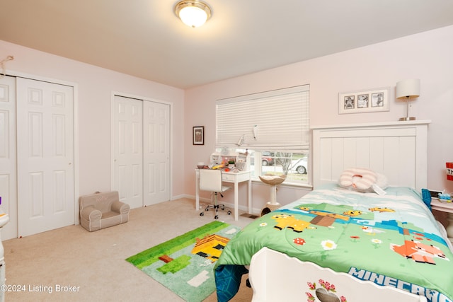 bedroom featuring carpet flooring and two closets