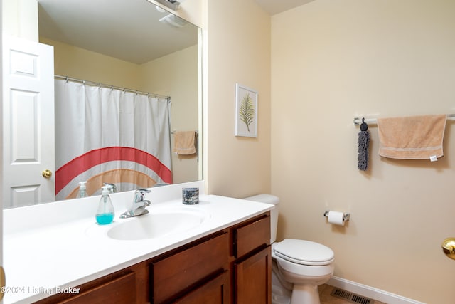 bathroom featuring toilet and vanity