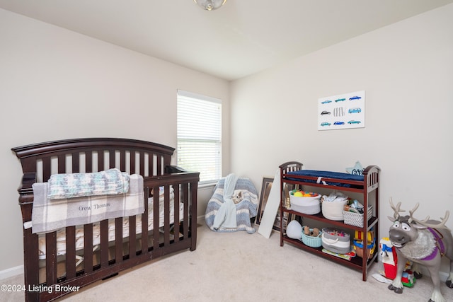 bedroom featuring carpet flooring and a crib