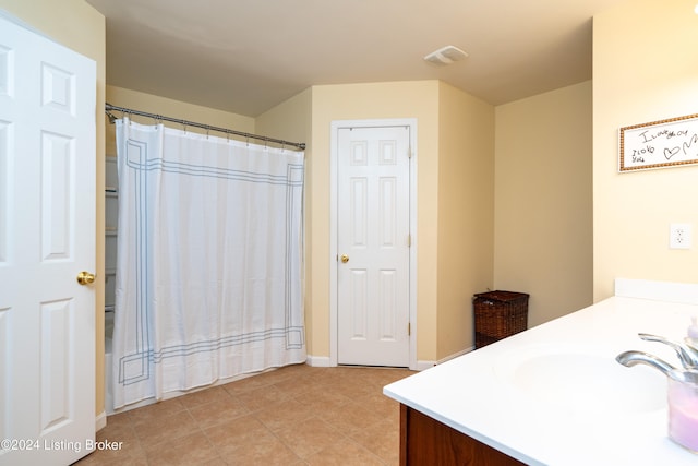 bathroom featuring shower / bath combo, vanity, and tile patterned flooring