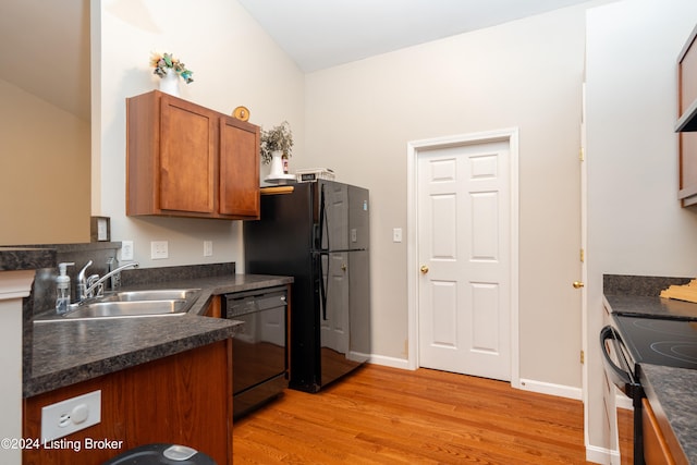 kitchen featuring light wood-type flooring, sink, and black appliances