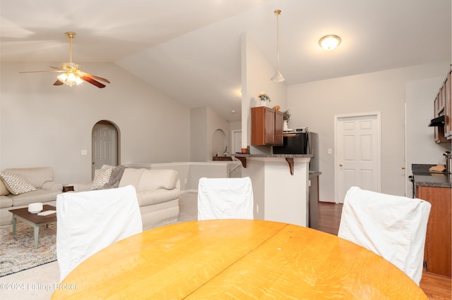 dining space featuring lofted ceiling, ceiling fan, and light hardwood / wood-style flooring