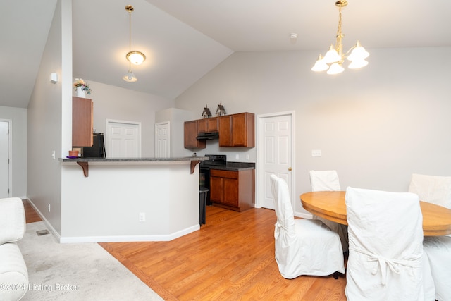 dining area with high vaulted ceiling, light hardwood / wood-style flooring, and a notable chandelier