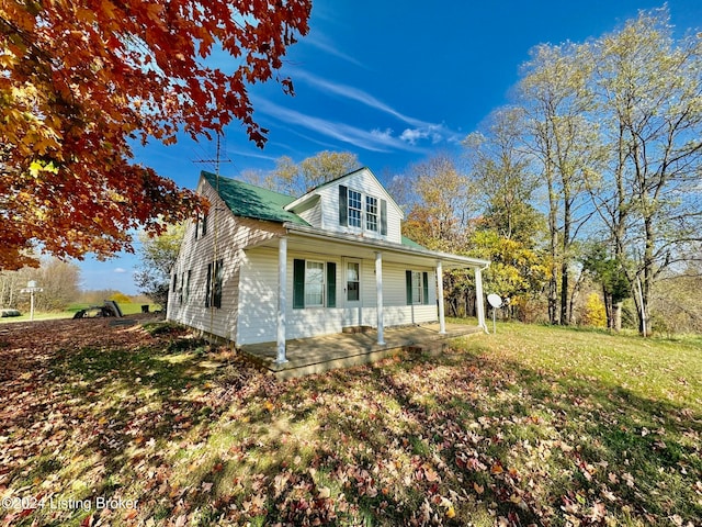 view of property exterior featuring a lawn and a porch