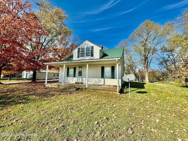 view of front facade with a front yard and covered porch