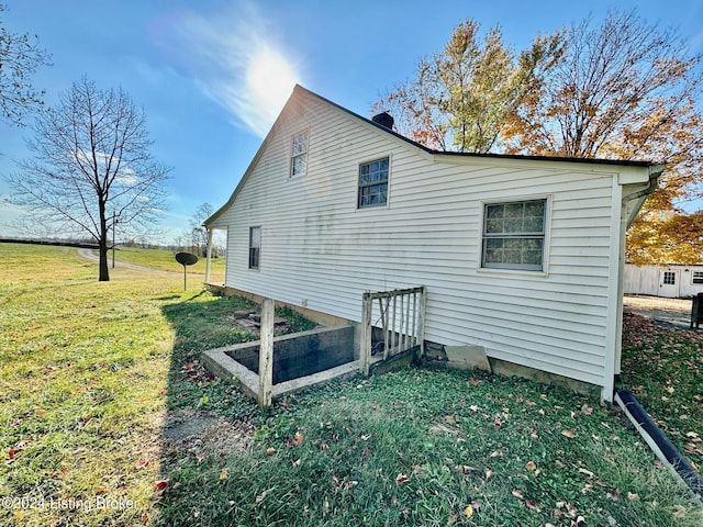 view of side of home featuring a lawn