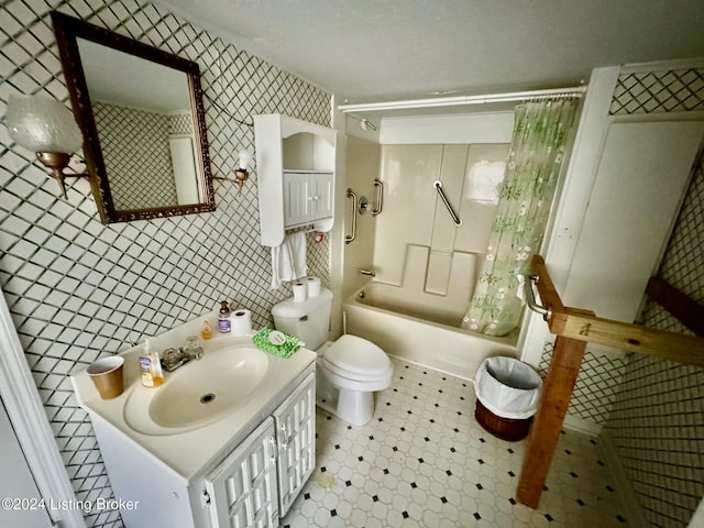 full bathroom with vanity, toilet, tile walls, and shower / bath combo with shower curtain