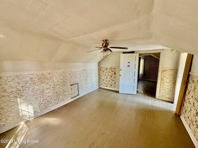 bonus room with ceiling fan, wood-type flooring, and vaulted ceiling