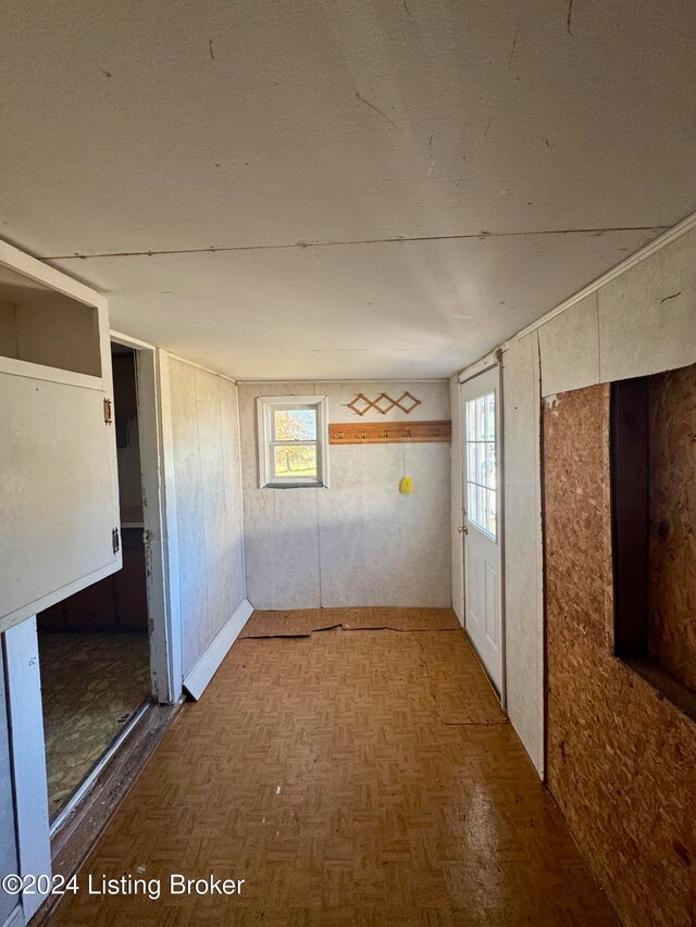 spare room with plenty of natural light and parquet flooring