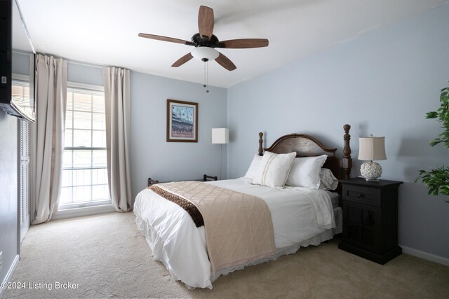 bedroom with ceiling fan and light carpet