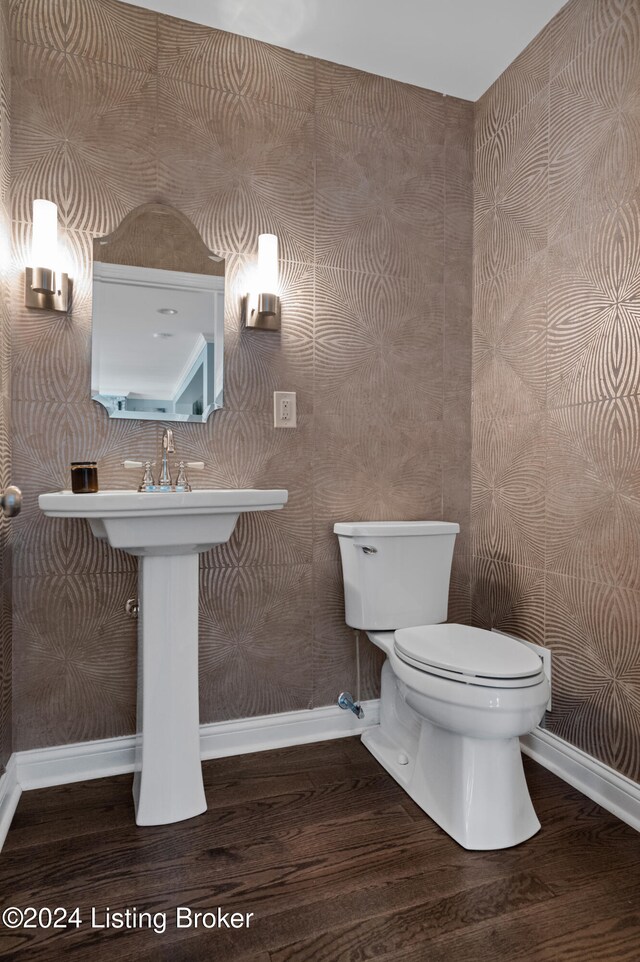 bathroom featuring hardwood / wood-style floors and toilet