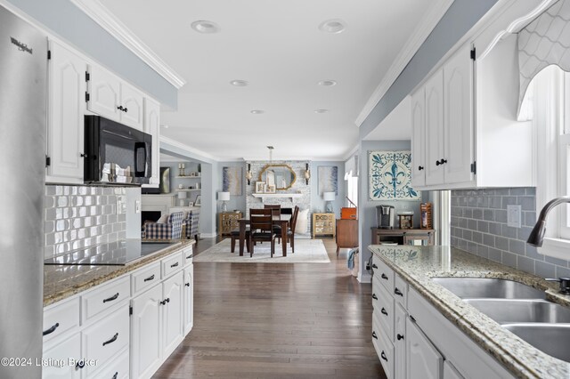 kitchen featuring sink, white cabinetry, dark hardwood / wood-style floors, ornamental molding, and black appliances