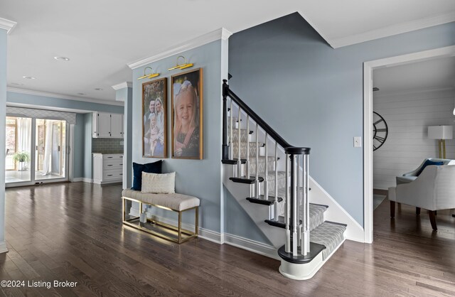 stairway with ornamental molding and wood-type flooring