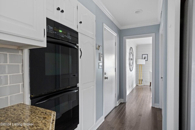 hallway with ornamental molding and dark hardwood / wood-style floors