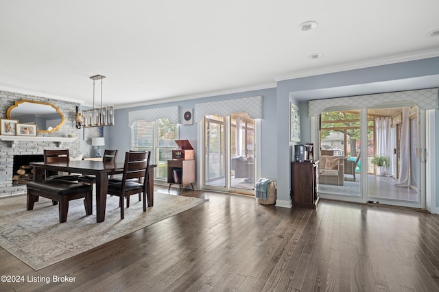 dining area featuring dark wood-type flooring, ornamental molding, and a wealth of natural light