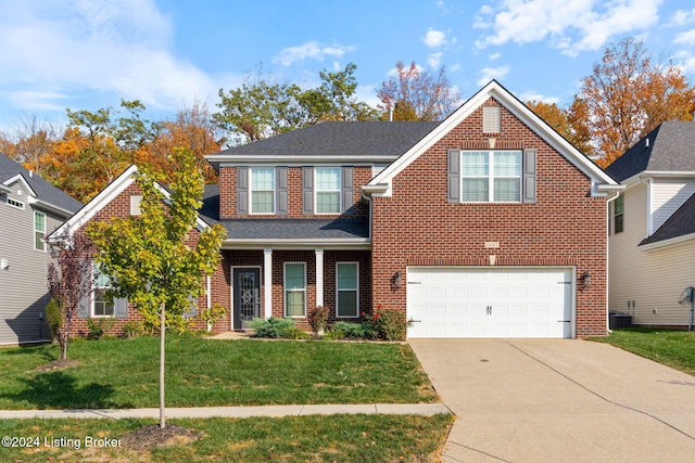 view of front of house featuring a front yard and a garage