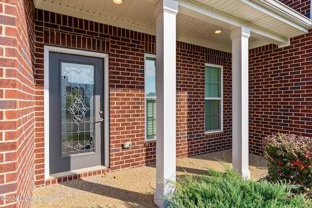 view of exterior entry featuring a porch