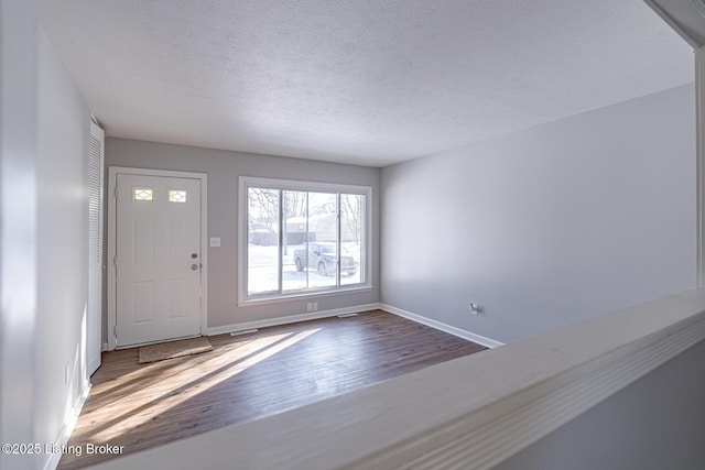 foyer featuring a textured ceiling and hardwood / wood-style flooring