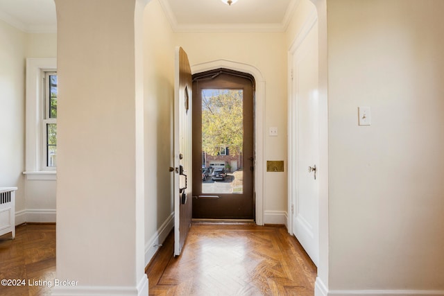 entryway featuring parquet flooring and ornamental molding