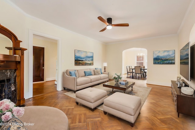 living room featuring parquet flooring, ornamental molding, and ceiling fan