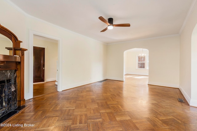 unfurnished living room featuring crown molding, dark parquet floors, a high end fireplace, and ceiling fan