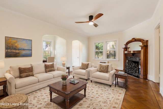 living room with parquet flooring, a healthy amount of sunlight, and ornamental molding