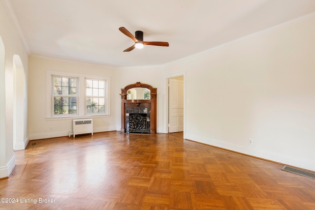 unfurnished living room featuring parquet flooring, crown molding, radiator, and ceiling fan