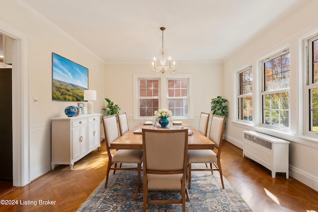 dining area with a notable chandelier, dark parquet floors, radiator heating unit, and ornamental molding