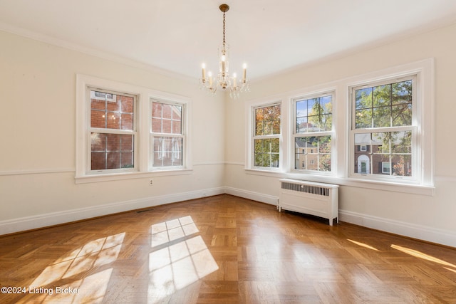 unfurnished dining area featuring a notable chandelier, ornamental molding, radiator, and a wealth of natural light