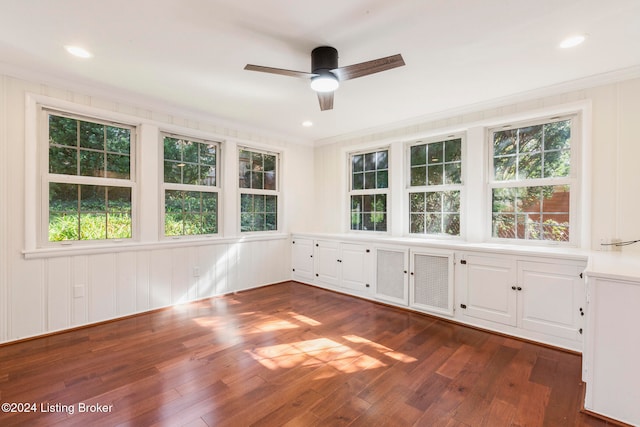 spare room featuring crown molding, ceiling fan, and dark hardwood / wood-style flooring