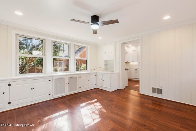 interior space featuring ornamental molding, dark hardwood / wood-style floors, and ceiling fan