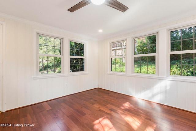 unfurnished room with crown molding, wood-type flooring, and ceiling fan