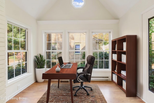 home office featuring light hardwood / wood-style floors, lofted ceiling, and a baseboard radiator