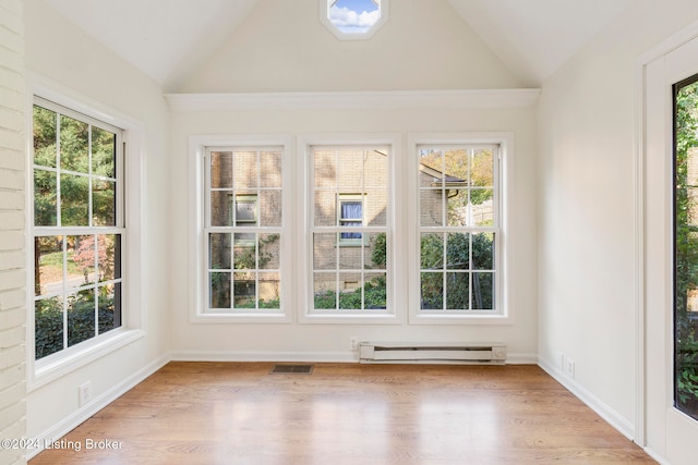 unfurnished sunroom featuring vaulted ceiling and a baseboard heating unit