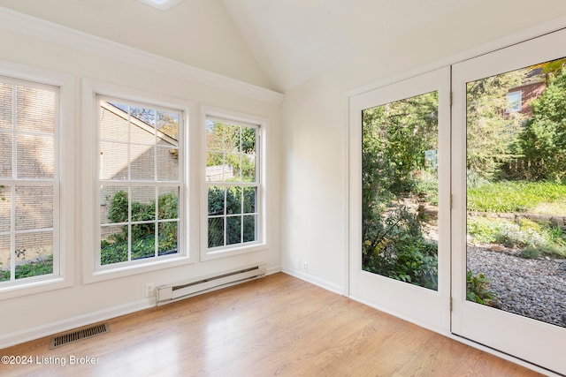 unfurnished sunroom featuring lofted ceiling and a baseboard radiator