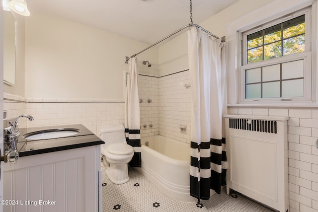 full bathroom with tile walls, shower / bathtub combination with curtain, toilet, and radiator