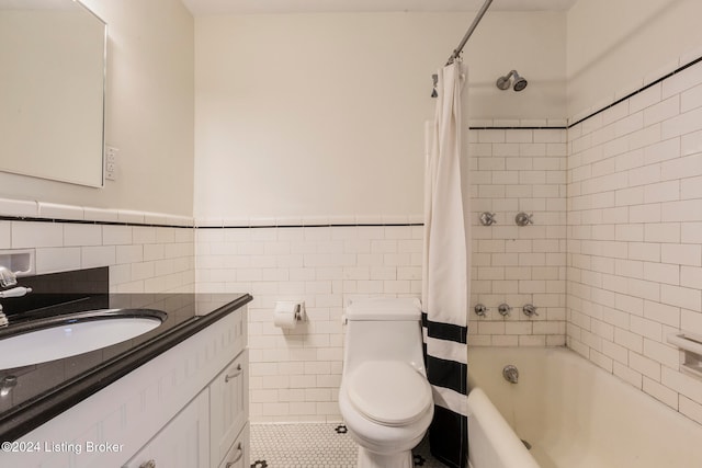 full bathroom with shower / bath combo, toilet, tile walls, vanity, and tile patterned flooring