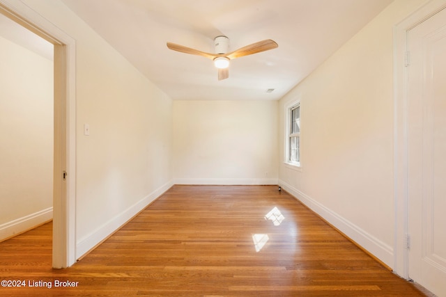 empty room with ceiling fan and wood-type flooring