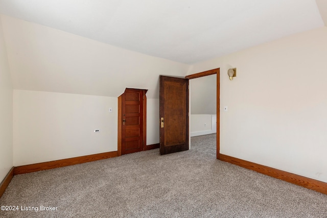 interior space featuring vaulted ceiling and carpet floors