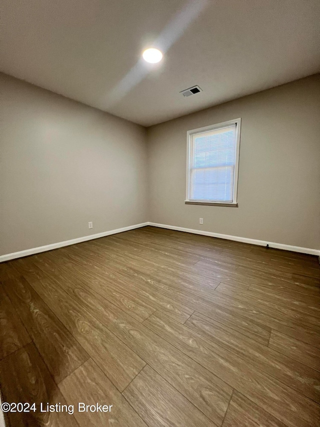 unfurnished room with wood-type flooring