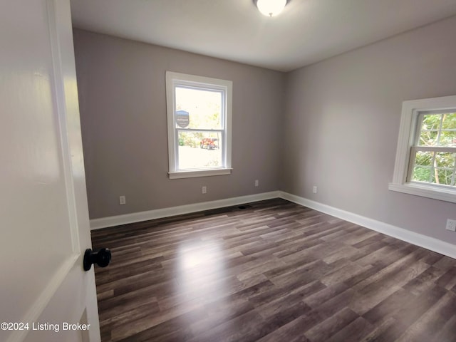 empty room featuring dark wood-type flooring