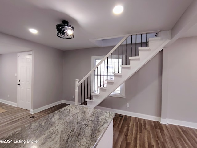 staircase with hardwood / wood-style flooring