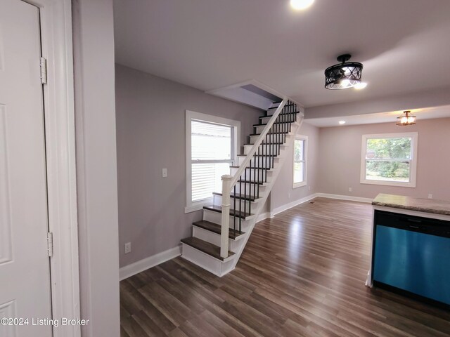 stairs featuring wood-type flooring