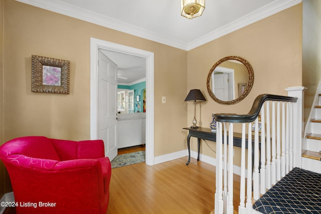 sitting room featuring ornamental molding and hardwood / wood-style flooring