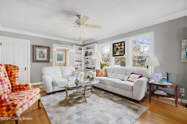 living room with crown molding, light wood-type flooring, and ceiling fan