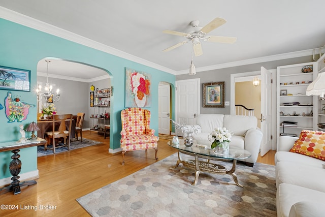 living room featuring ornamental molding, hardwood / wood-style floors, and ceiling fan with notable chandelier