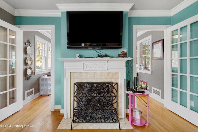 living room with hardwood / wood-style floors and crown molding