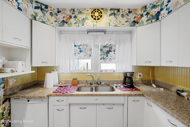 kitchen with white cabinetry, light stone counters, sink, and dishwasher