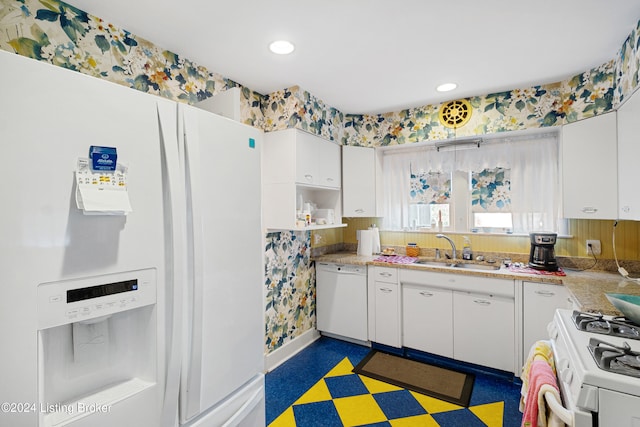 kitchen featuring white appliances, white cabinetry, and sink